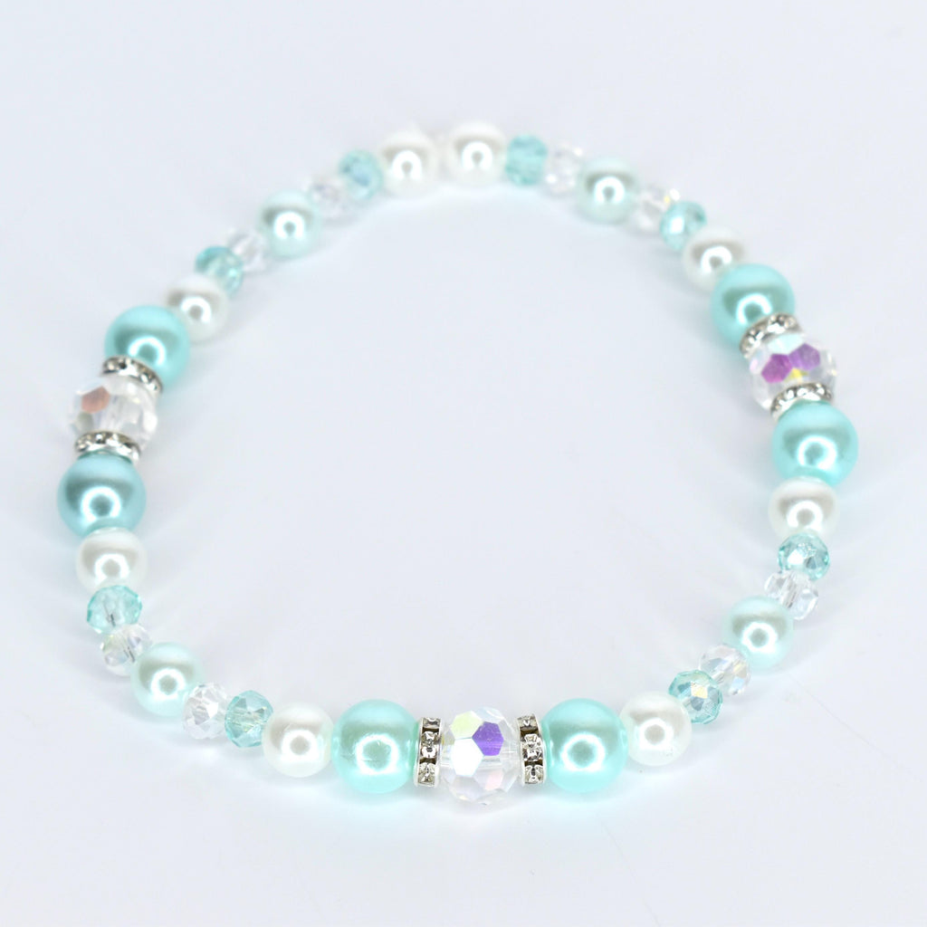 A delicate bracelet featuring a mix of round, light blue, white, and clear beads. The bracelet includes iridescent crystal accents and is strung together with a clear, flexible cord. The beads are a mix of sizes and textures.