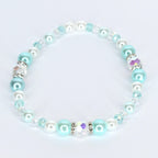 A delicate bracelet featuring a mix of round, light blue, white, and clear beads. The bracelet includes iridescent crystal accents and is strung together with a clear, flexible cord. The beads are a mix of sizes and textures.