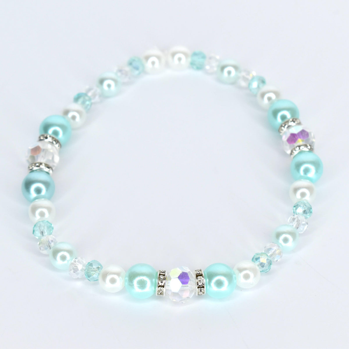 A delicate bracelet featuring a mix of round, light blue, white, and clear beads. The bracelet includes iridescent crystal accents and is strung together with a clear, flexible cord. The beads are a mix of sizes and textures.