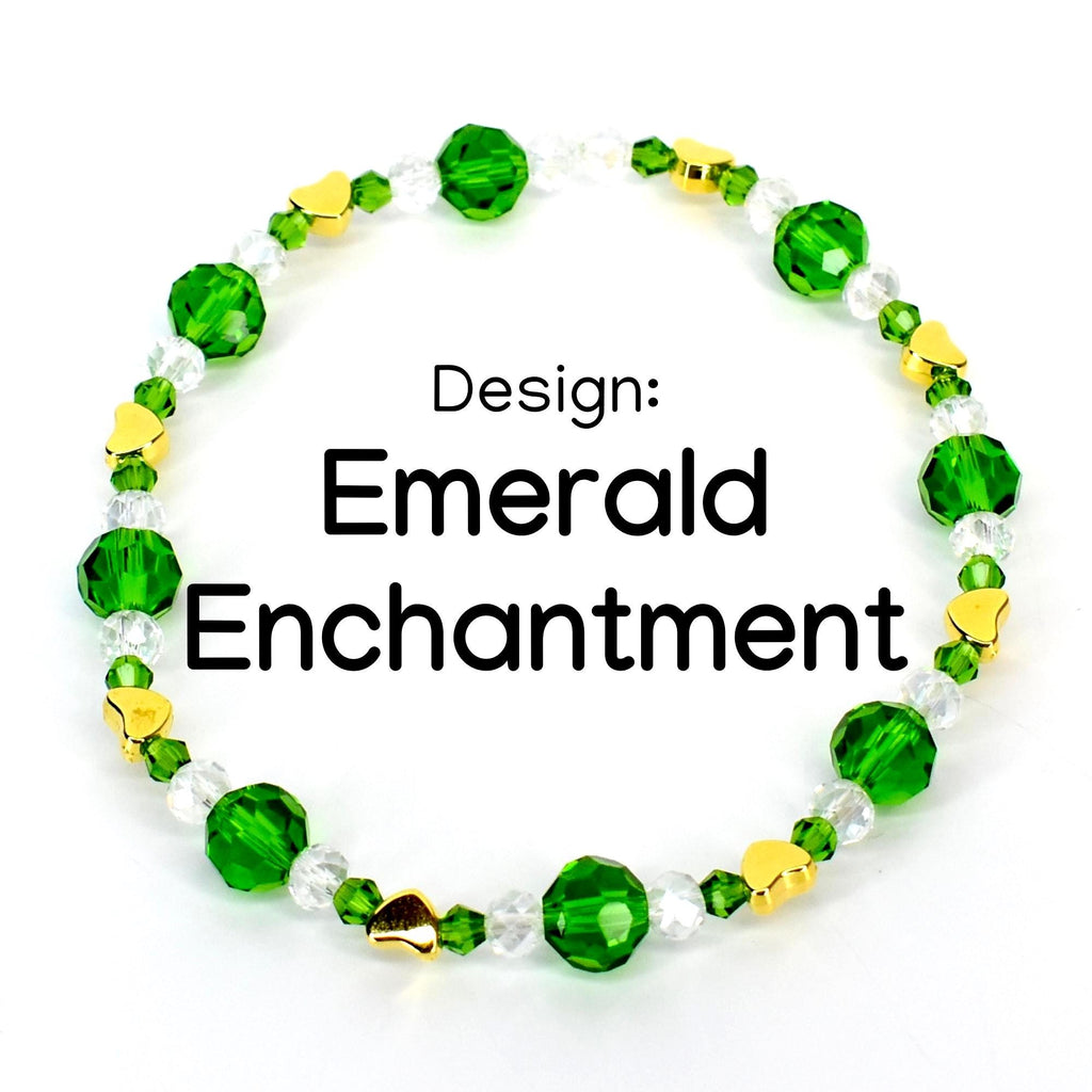A beaded bracelet with the text "Emerald Enchantment." The bracelet features faceted emerald green beads, clear beads, and small gold heart-shaped beads. The design is set against a white background.