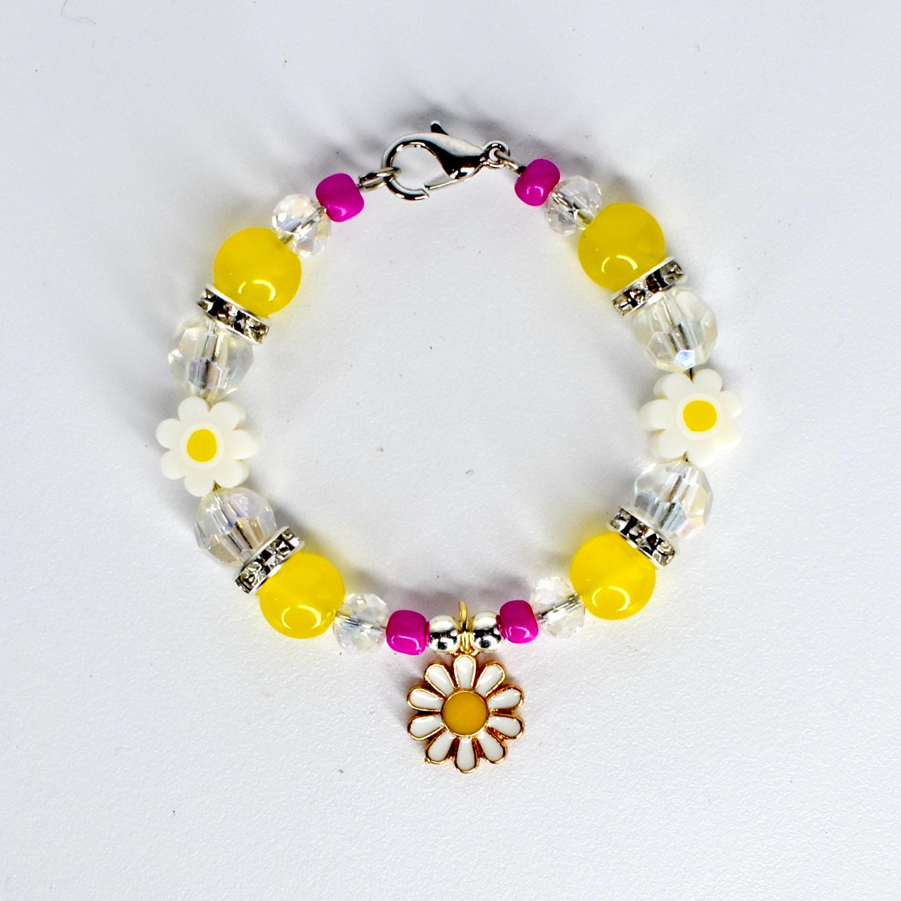 A beaded tumbler handle bracelet with yellow, clear, and fuchsia beads. The bracelet features white daisy-shaped beads and a gold-colored daisy charm. The bracelet is secured with a silver-colored clasp.