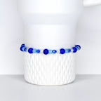 A cobalt blue, sky blue and crystal beaded tumbler bracelet on a white Stanley tumbler. Made for cobalt blue stanley and sky blue stanley.