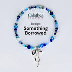 A beaded bracelet with a variety of blue and clear beads. The bracelet has a silver-colored bow charm. The text "Calathea Collective" and "Design: Something Borrowed" are displayed on the image.
