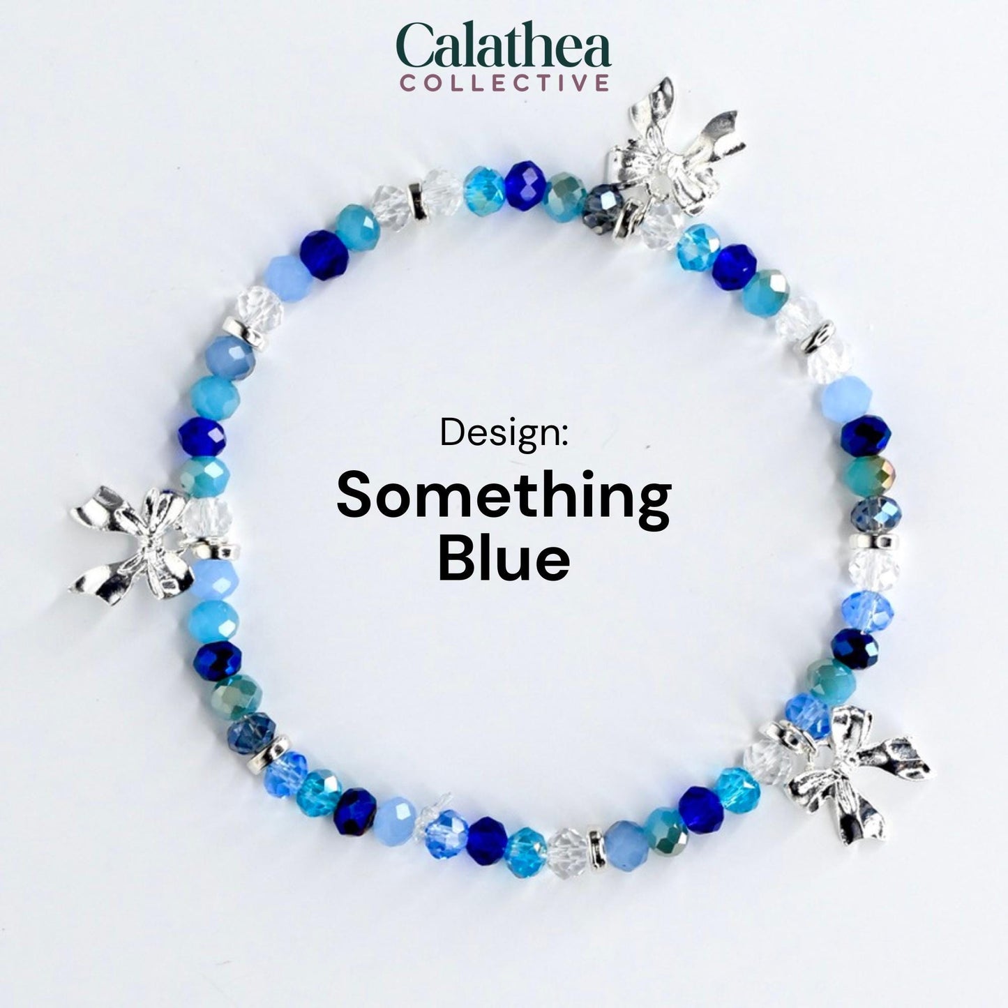 A beaded bracelet with a variety of blue beads and silver bow charms. The bracelet is labeled "Something Blue" and is from the Calathea Collective.