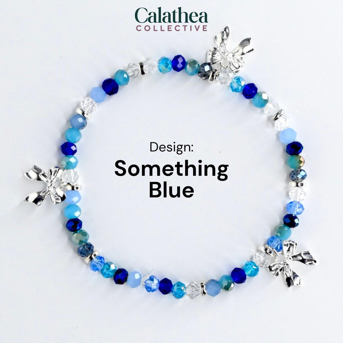 A beaded bracelet with a variety of blue beads and silver bow charms. The bracelet is labeled "Something Blue" and is from the Calathea Collective.