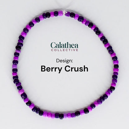 A beaded bracelet in a circular shape, featuring a mix of purple and dark purple beads. The text "Calathea Collective" and "Berry Crush" are displayed on the image.