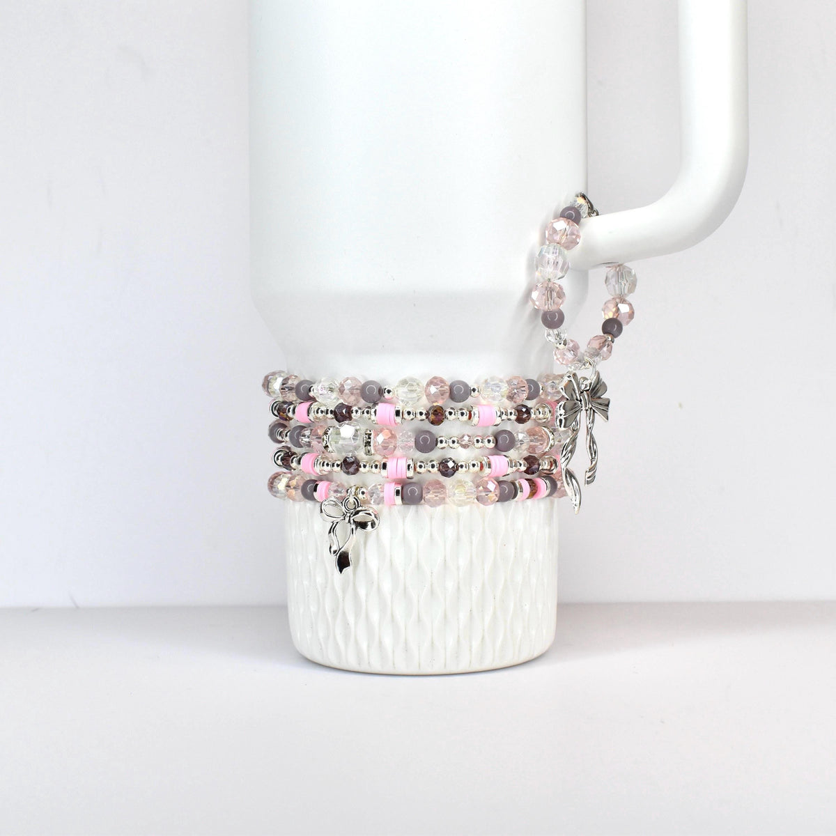 A set of three ceramic mugs with a speckled, matte finish. The mugs are in shades of cream, light brown, and dark brown. Each mug has a simple, minimalist design, perfect for coffee or tea.