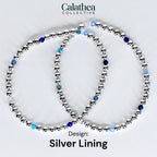 Two silver beaded bracelets with blue and clear accent beads. The bracelets are arranged in a circular shape. The text "Calathea Collective" is at the top, and "Design: Silver Lining" is at the bottom.