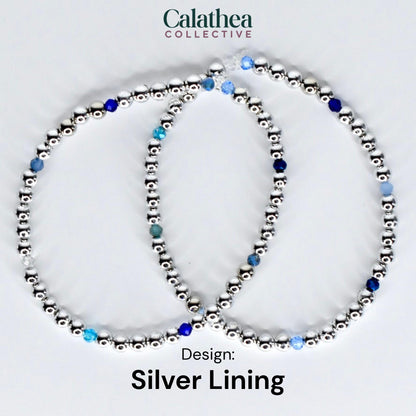 Two silver beaded bracelets with blue and clear accent beads. The bracelets are arranged in a circular shape. The text "Calathea Collective" is at the top, and "Design: Silver Lining" is at the bottom.