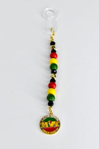 A Juneteenth-themed straw charm with a clear plastic straw adapter at the top. The charm features a string of red, yellow, green, and black beads, and a gold-colored pendant with the words "Juneteenth Since 1865" and a graphic of two hands.