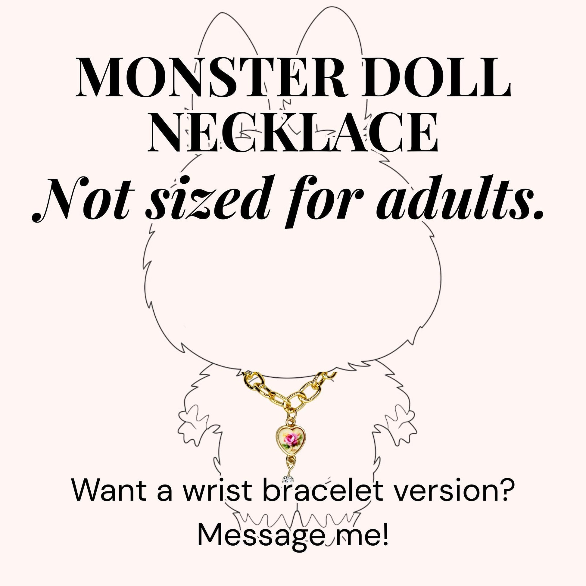 A gold-colored necklace with a heart-shaped pendant featuring a pink rose design. The image includes the text "MONSTER DOLL NECKLACE" and "Not sized for adults." The text "Want a wrist bracelet version? Message me!" is also present.