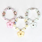 Three beaded tumbler handle bracelets with flower pendants. The bracelets feature a variety of beads in pink, yellow, and green, with silver-tone accents. Each bracelet has a flower-shaped pendant in a matching color.