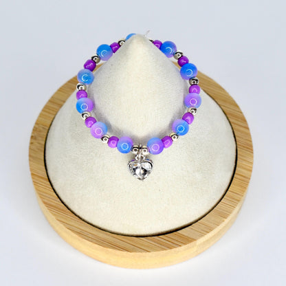 A beaded 17cm monster doll necklace featuring blue, purple, and silver beads. The necklace has a silver heart-shaped charm. The beads are arranged in a pattern of alternating colors. The necklace is displayed on a white surface.