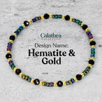 A beaded bracelet with the text "Calathea Collective" and "Design Name: Hematite & Gold". The bracelet features black, gold, and iridescent beads. The beads are strung together to form a circular shape.