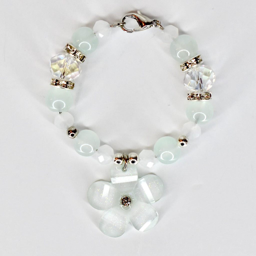 A delicate tumbler handle bracelet featuring a flower charm and a mix of light blue and white beads. The tumbler bracelet has a silver clasp and decorative crystal beads. The flower charm has a central crystal accent.