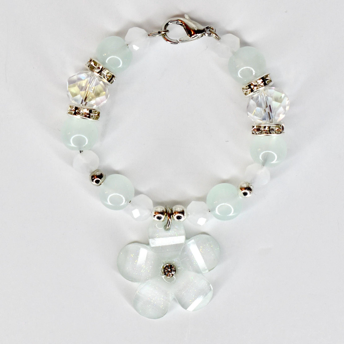 A delicate tumbler handle bracelet featuring a flower charm and a mix of light blue and white beads. The tumbler bracelet has a silver clasp and decorative crystal beads. The flower charm has a central crystal accent.