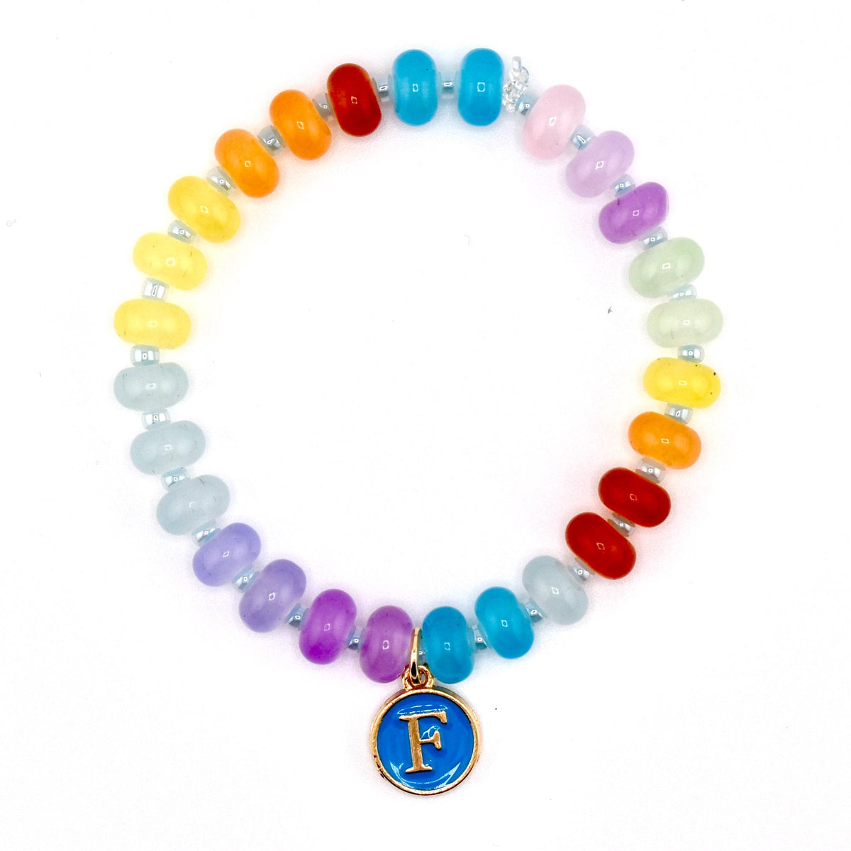 A colorful beaded bracelet with a rainbow of colors, including red, orange, yellow, green, blue, and purple. The bracelet has a gold-colored charm with a blue background and the letter "F".