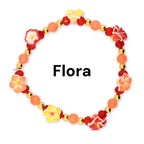 A handmade beaded bracelet with red orange and yellow flower beads with gold accents.