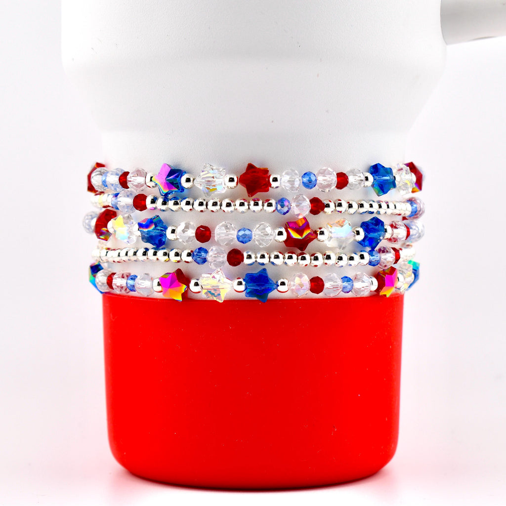 A set of five beaded bracelet with red white blue and crystal beads. There are sparkling patriotic star beads and small silver spacer beads.