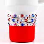 A set of five beaded bracelet with red white blue and crystal beads. There are sparkling patriotic star beads and small silver spacer beads.