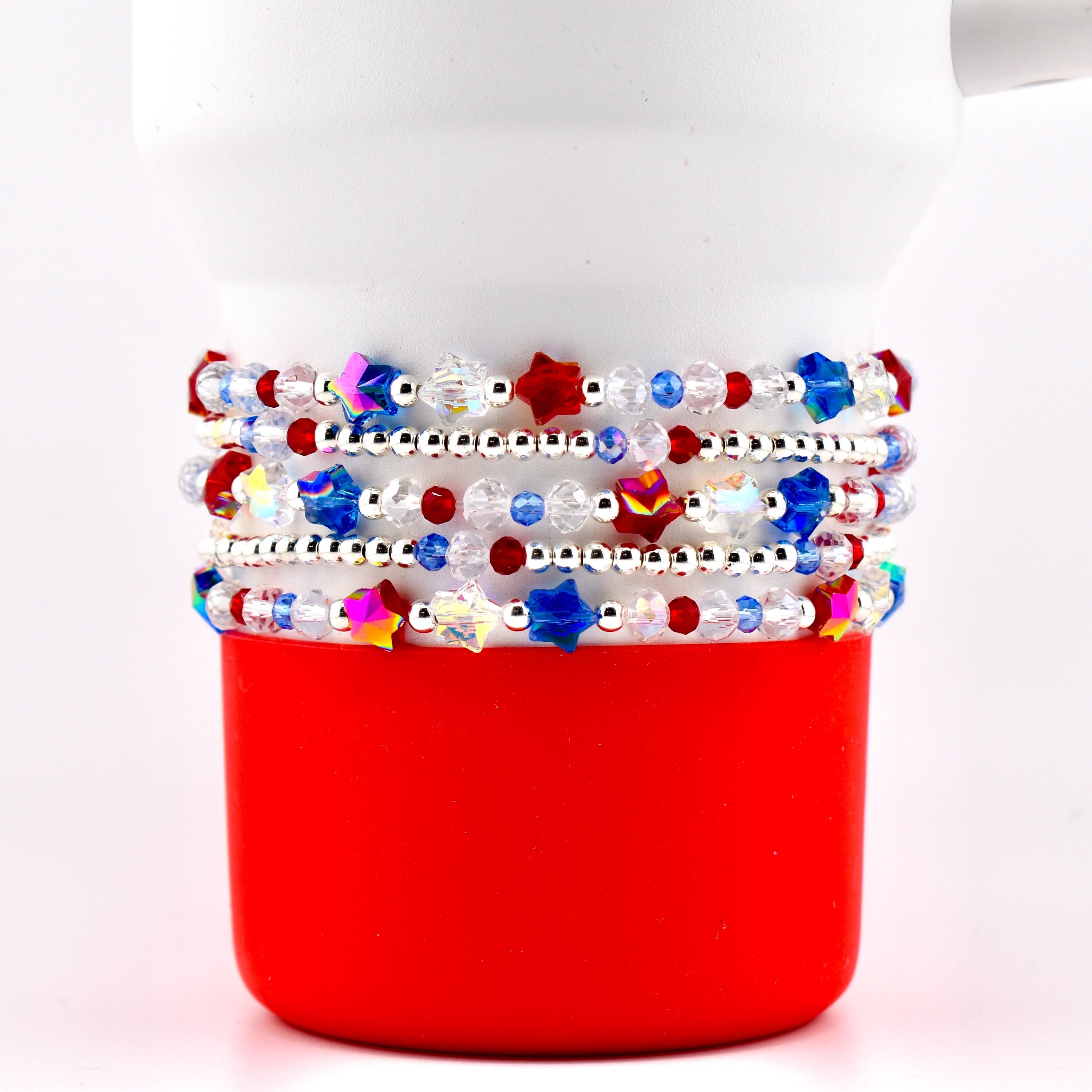 A set of five beaded bracelet with red white blue and crystal beads. There are sparkling patriotic star beads and small silver spacer beads.