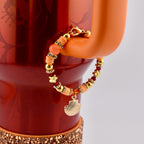 Orange Red and Gold Tumbler Handle Charm Bracelet with Shell Charm
