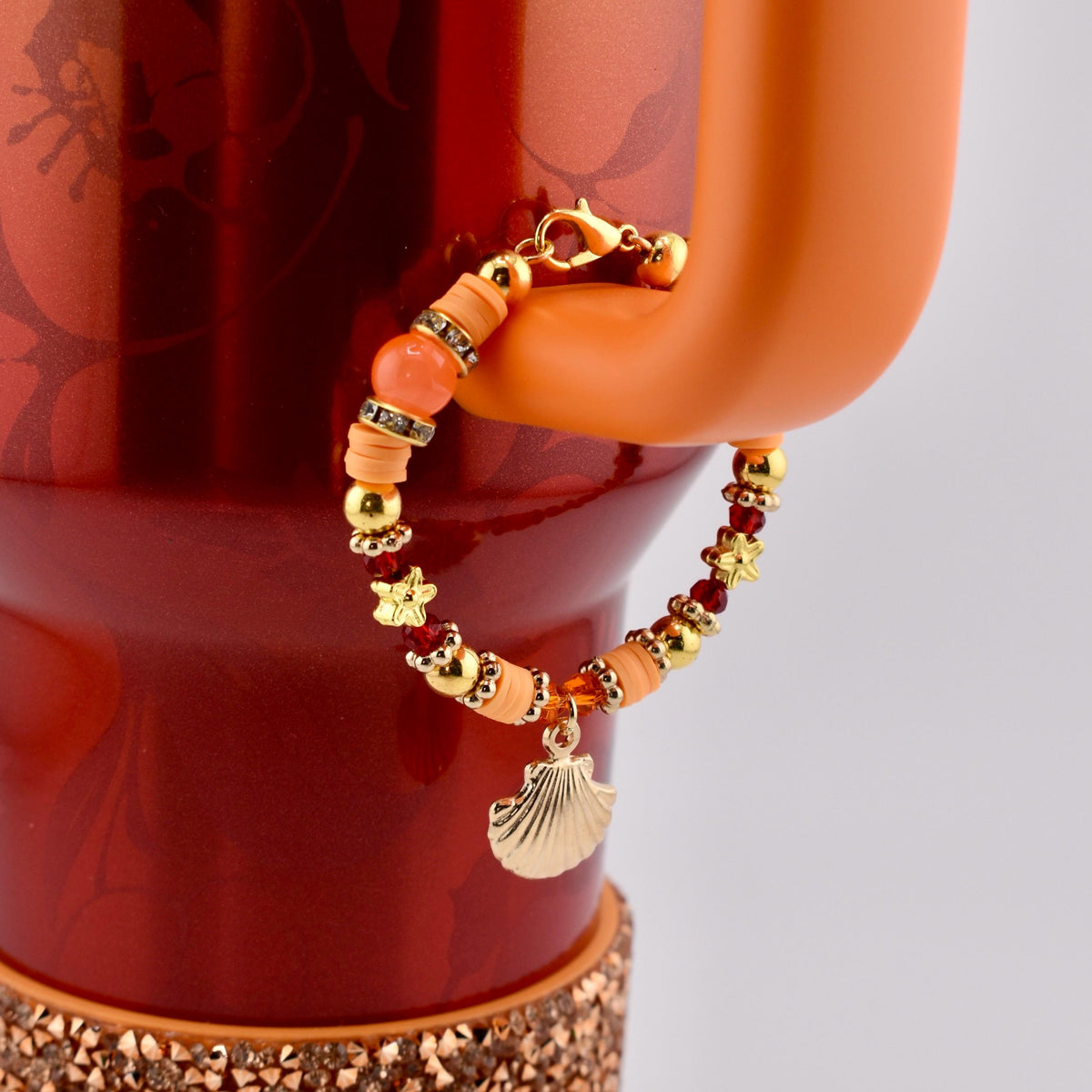 Orange Red and Gold Tumbler Handle Charm Bracelet with Shell Charm