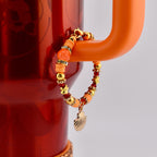 Orange Red and Gold Tumbler Handle Charm Bracelet with Shell Charm