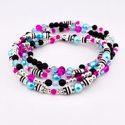 A set of four beaded bracelets in a spiral arrangement. The bracelets feature a mix of black, pink, light blue, and clear beads, along with silver and black striped accents. The beads are strung on a silver wire.