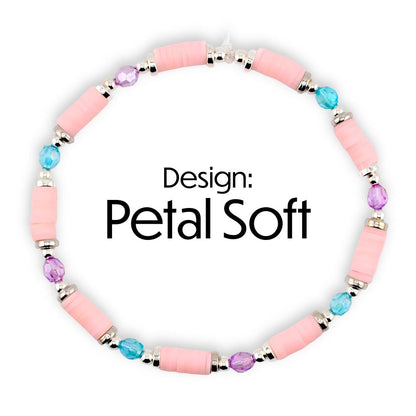 A pink beaded bracelet with silver accents and colorful beads. The bracelet features pink cylindrical beads, interspersed with blue and purple beads. The text "Design: Petal Soft" is displayed in black.