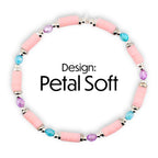A pink beaded bracelet with silver accents and colorful beads. The bracelet features pink cylindrical beads, interspersed with blue and purple beads. The text "Design: Petal Soft" is displayed in black.