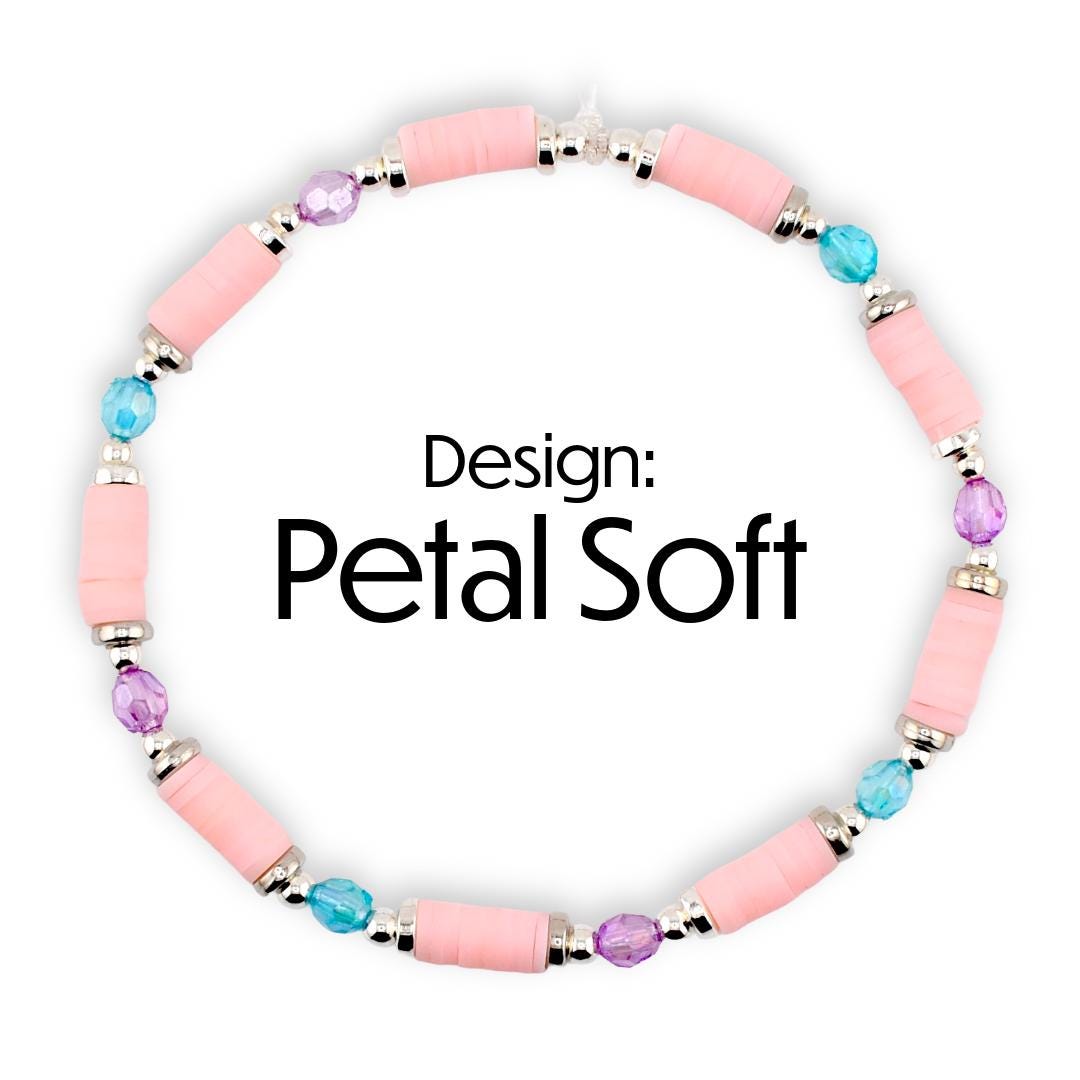 A pink beaded bracelet with silver accents and colorful beads. The bracelet features pink cylindrical beads, interspersed with blue and purple beads. The text "Design: Petal Soft" is displayed in black.