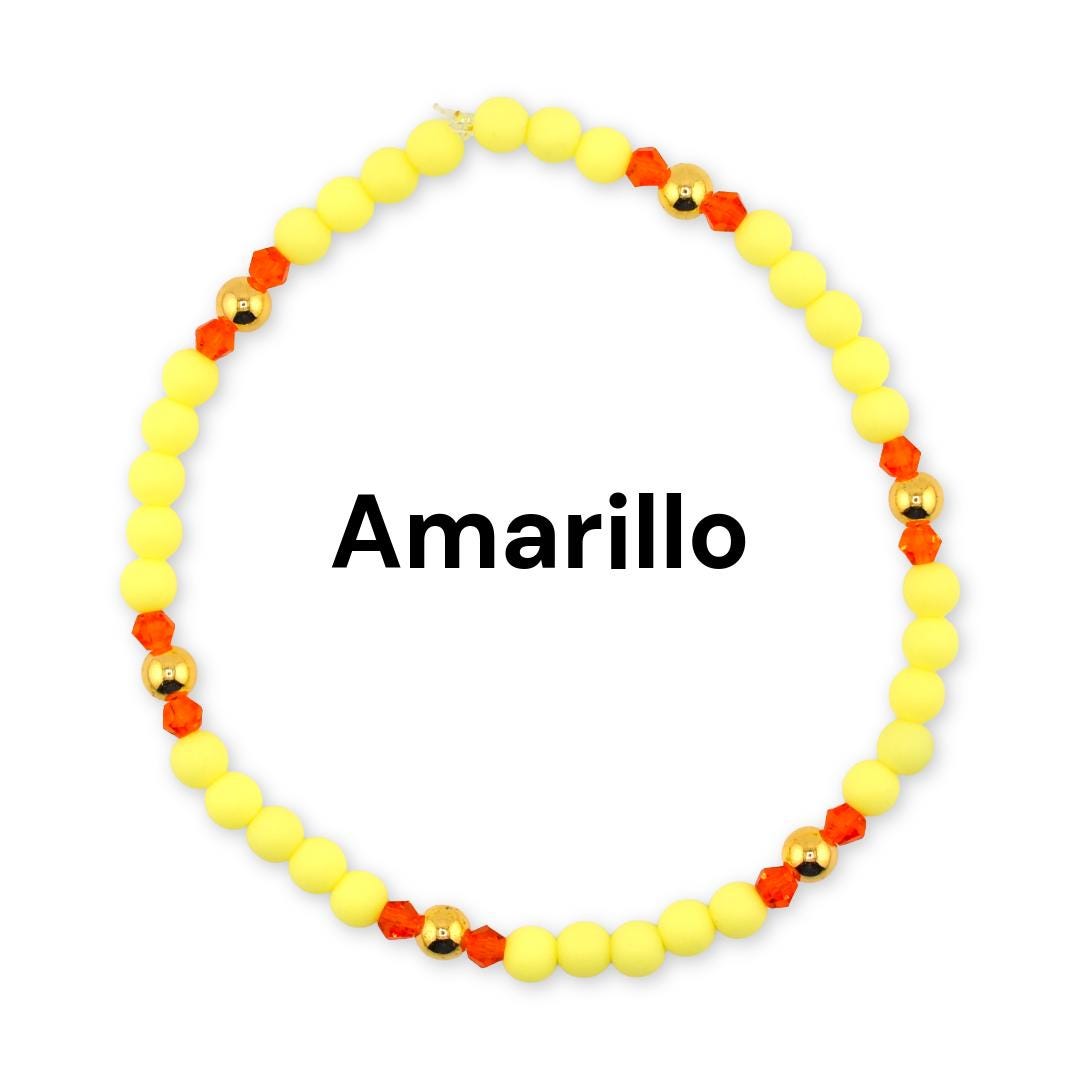 A bracelet with bright yellow, orange and gold beads. The word Amarillo is in the center as the design name.