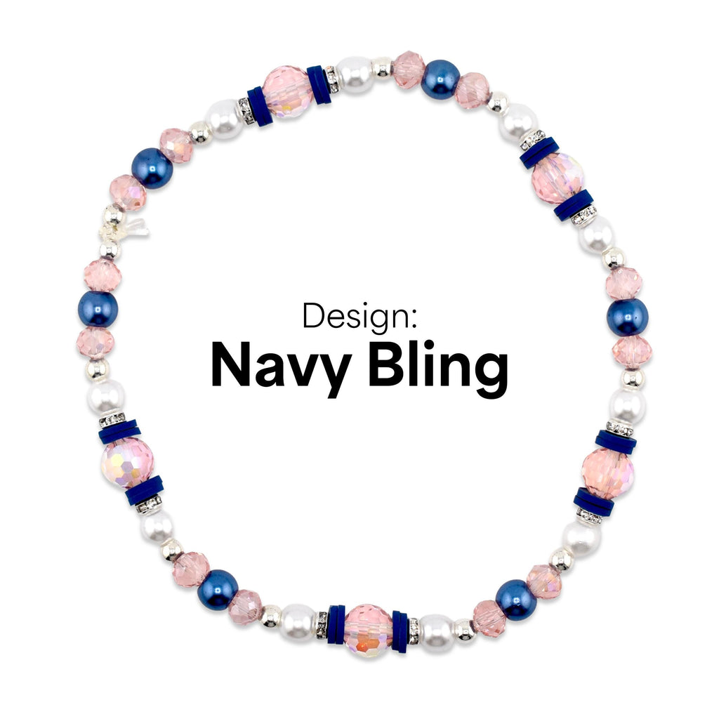 A beaded necklace with the text "Navy Bling". The necklace features a combination of pink, navy blue, and white beads. Accents include silver-colored spacers and navy blue velvet-like bands.