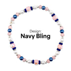 A beaded necklace with the text "Navy Bling". The necklace features a combination of pink, navy blue, and white beads. Accents include silver-colored spacers and navy blue velvet-like bands.