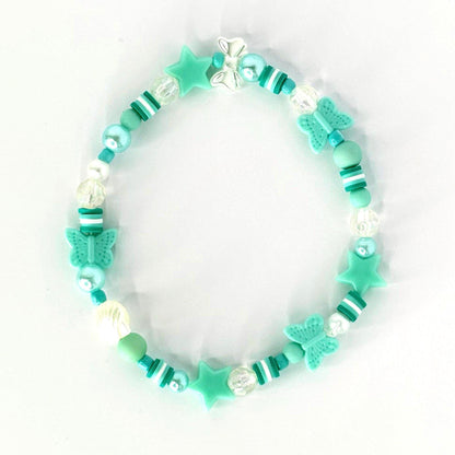A beaded bracelet featuring a mix of turquoise, white, and clear beads. The bracelet includes star and butterfly-shaped charms. The beads are strung together with a clear elastic cord, creating a playful and whimsical accessory.