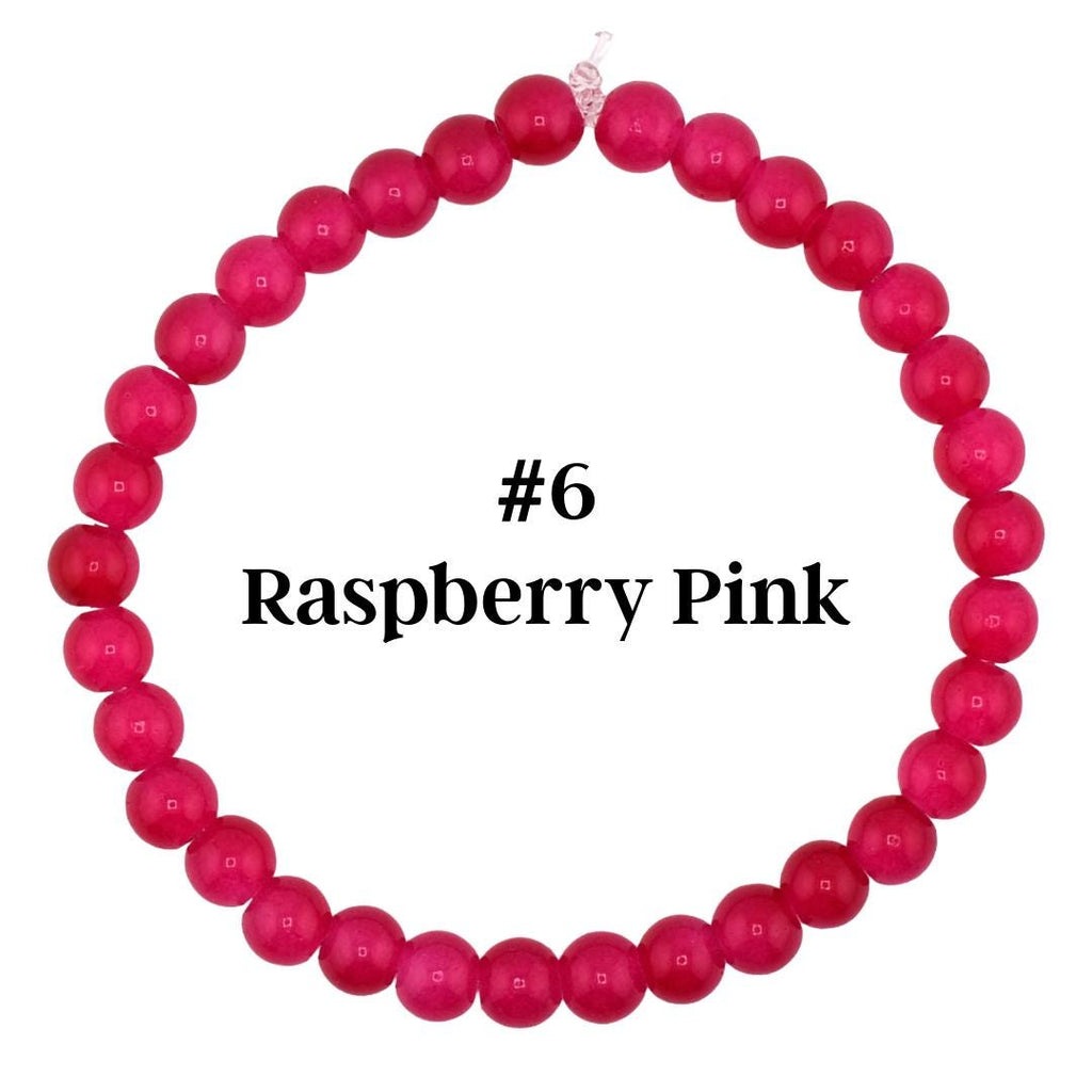 A raspberry pink beaded bracelet. The bracelet is made of small, round beads in a vibrant shade of pink. The text "#6 Raspberry Pink" is displayed in black font.