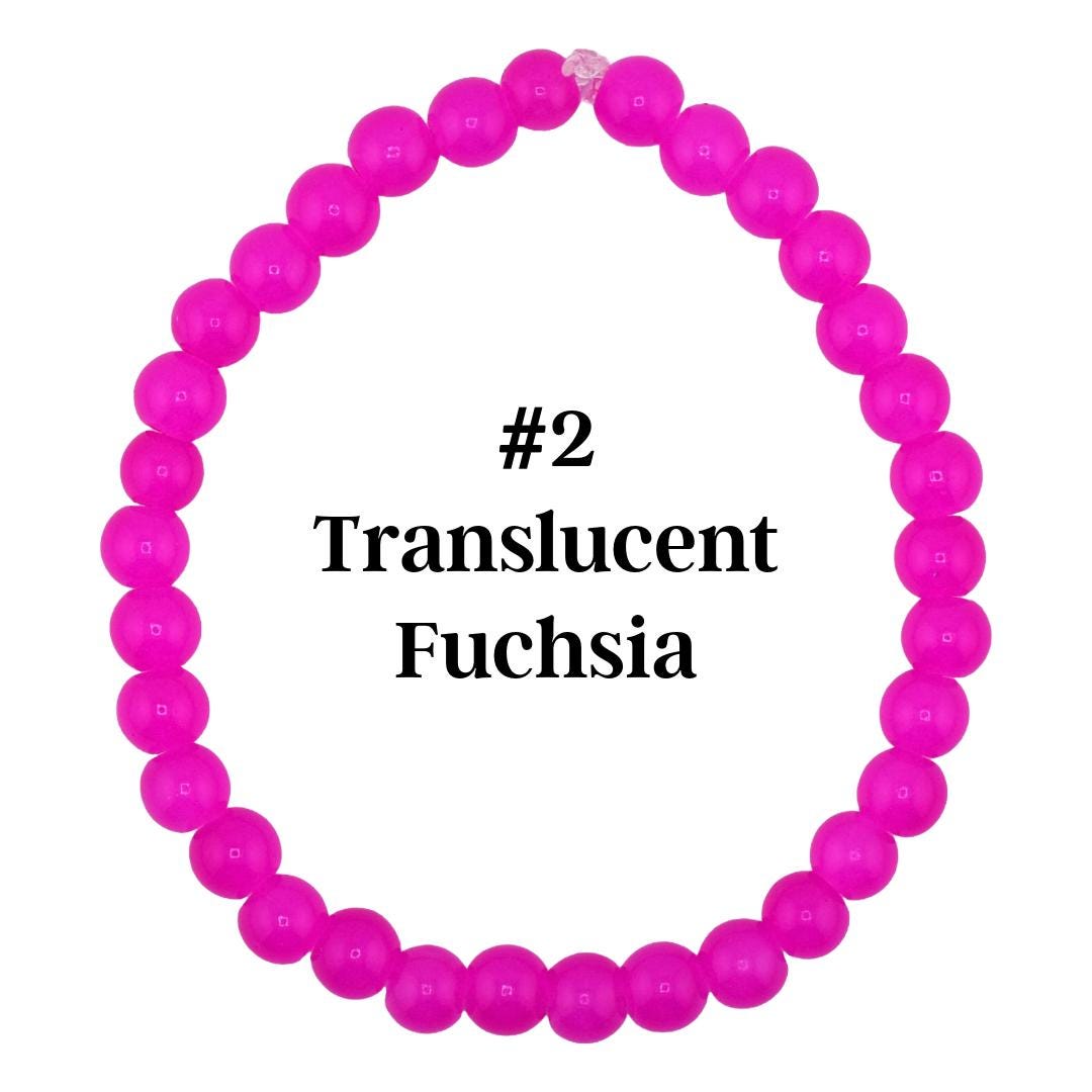 A translucent fuchsia beaded bracelet. The bracelet is made of round, bright pink beads. The text "#2 Translucent Fuchsia" is displayed in black font.