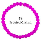 A bracelet made of bright pink, frosted beads. The beads are strung together to form a circular shape. The text "#4 Frosted Orchid" is in the center of the bracelet.