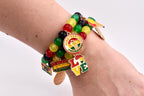 A beaded bracelet with red, yellow, green, and black beads. The bracelet features charms with the words "Juneteenth Freedom Day", "Black Queen", and "Love". The charms are in red, yellow, green, and black.
