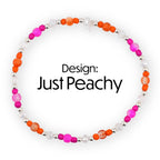A beaded bracelet with the text "Design: Just Peachy". The bracelet features a circular design with a mix of orange, pink, and clear beads. The beads are interspersed with silver-colored metal beads.