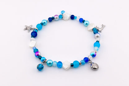 Blue ocean beaded charm bracelet with silver seashell charms, starfish charm and mermaid tail charm, mixed blue navy and turquoise pearl crystal and glass beads – handmade coastal beach bracelet nautical jewelry