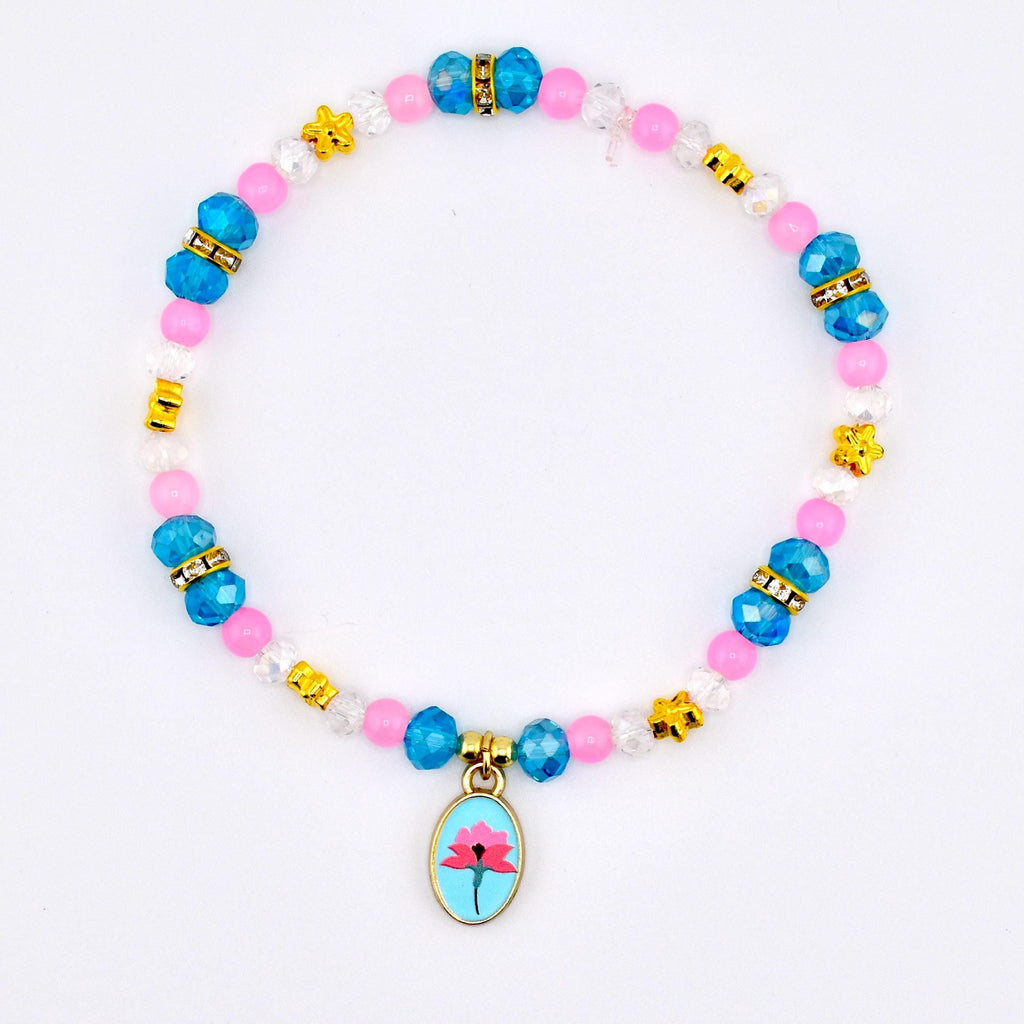 A beaded bracelet featuring pink, blue, and clear beads with gold accents. The bracelet includes a charm with a pink flower design on a light blue background. The bracelet is on a white background.