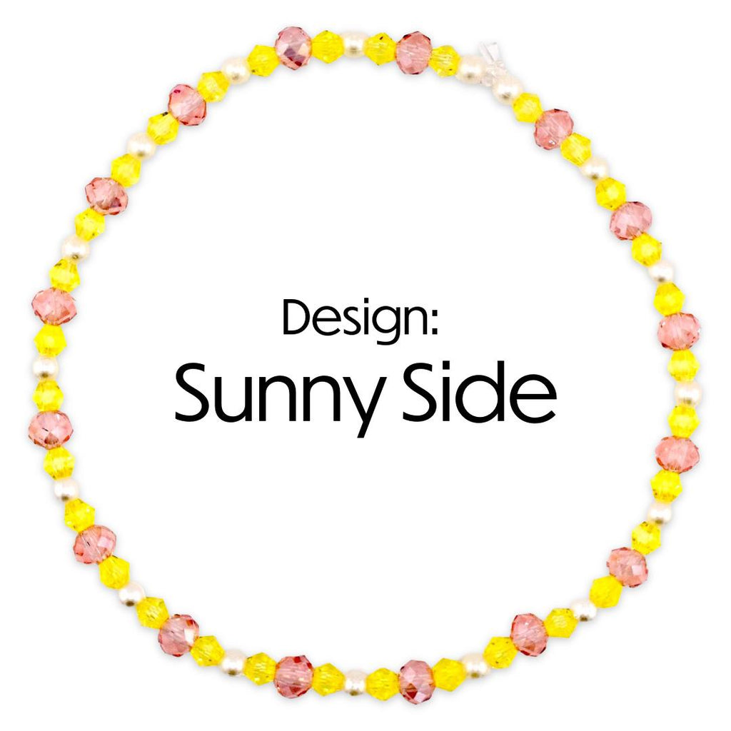 A circular beaded bracelet with yellow pink and white beads. The necklace features a design of yellow and pink faceted beads interspersed with white pearls. The text "Design: Sunny Side" is displayed in the center.