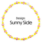 A circular beaded bracelet with yellow pink and white beads. The necklace features a design of yellow and pink faceted beads interspersed with white pearls. The text "Design: Sunny Side" is displayed in the center.