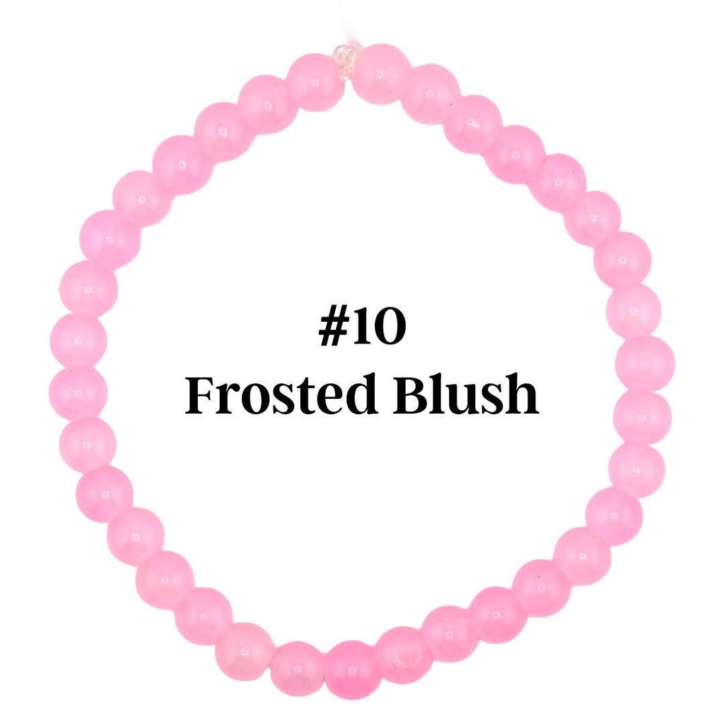 A light pink beaded bracelet with the text "#10 Frosted Blush". The bracelet is made of small, round beads strung together. The beads are a soft, pastel pink color.