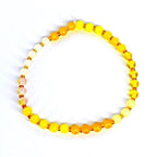 Handmade yellow beaded bracelet – elastic gemstone jewelry for wellness and balance.