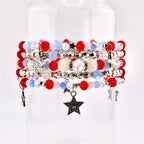 A stack of beaded bracelets in red, white, and blue. The bracelets feature various bead sizes and shapes, including round, faceted, and pearl-like beads. Some bracelets have star-shaped charms.