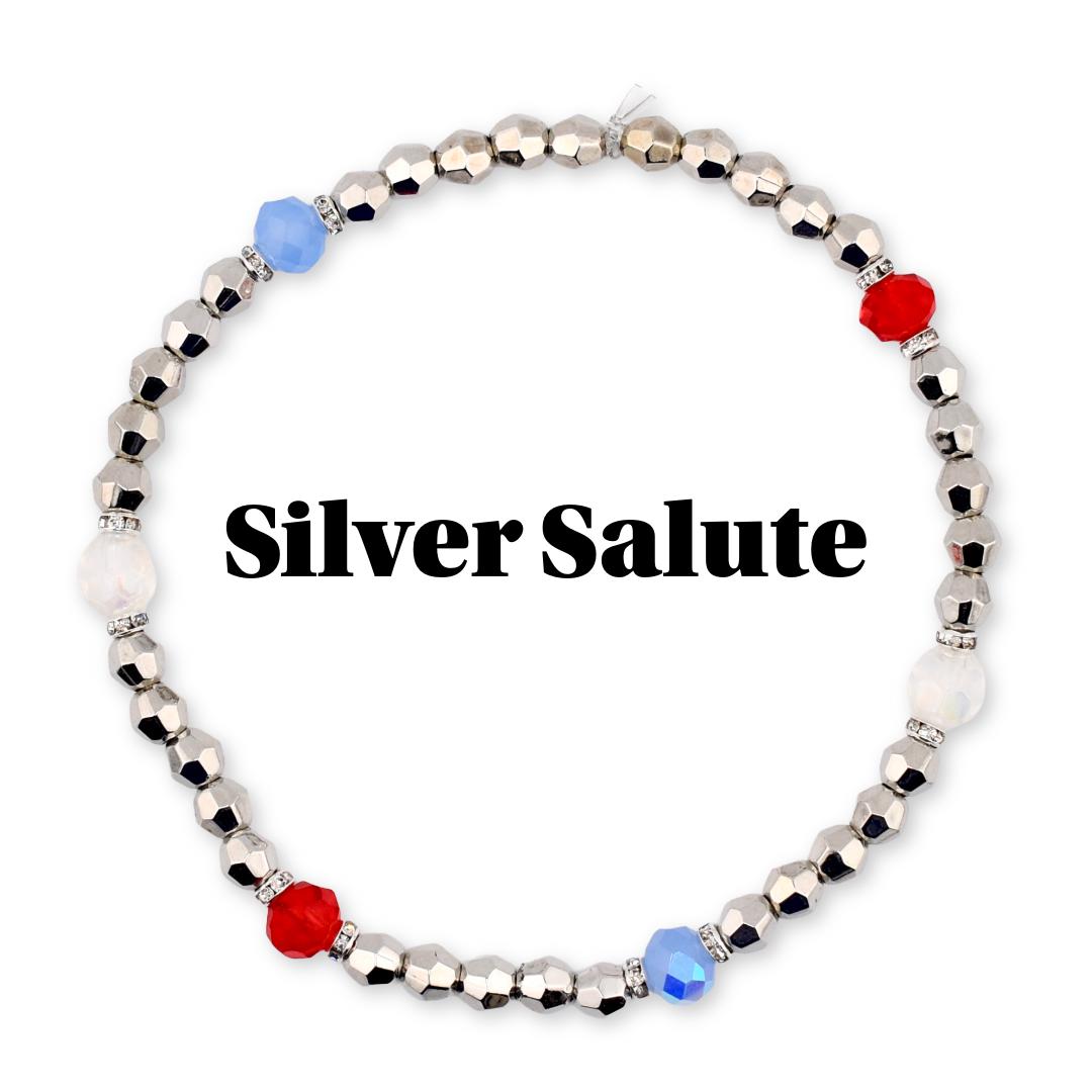 Silver beaded bracelet with faceted silver beads, interspersed with red, white, and blue accent beads. The text "Silver Salute" is displayed in black, bold font.