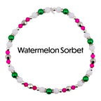 A beaded necklace with the text "Watermelon Sorbet". The necklace features white, green, pink, and silver beads. The beads are arranged in a circular pattern, creating a bracelet or anklet.